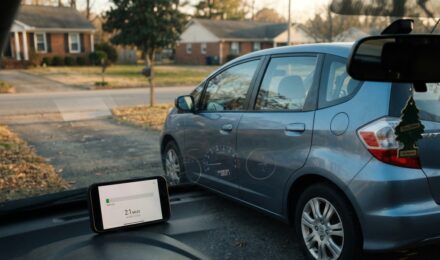 Low-mileage driver comparing pay per mile insurance options on a laptop