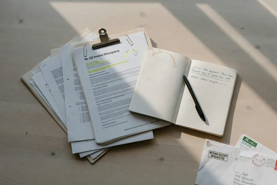 Organized insurance claim documents and denial letters laid out on a desk
