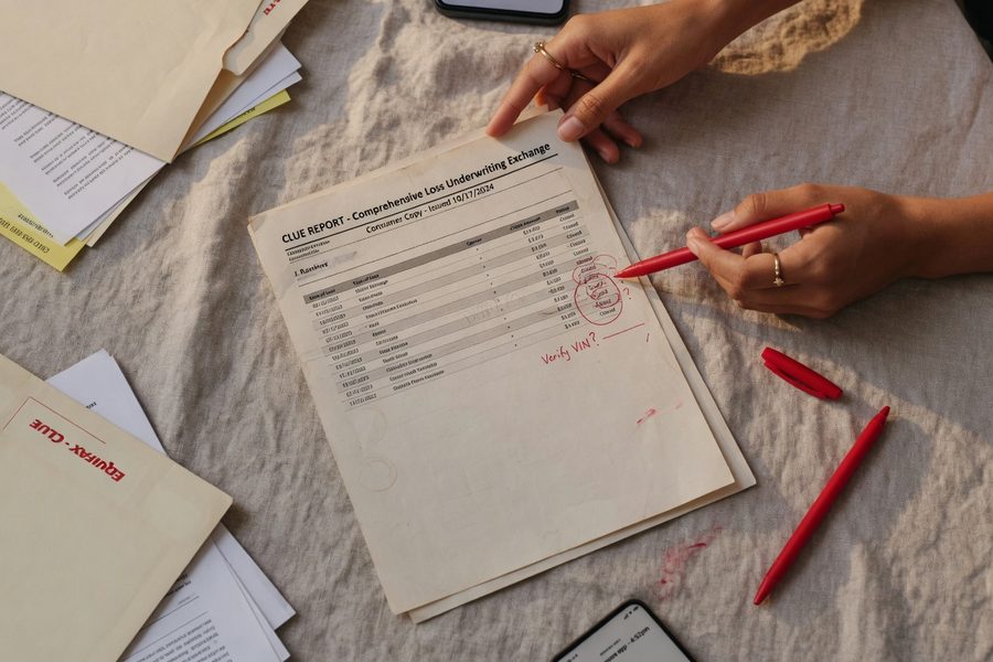 Split view of a CLUE report form beside a renewal premium notice showing a rate increase