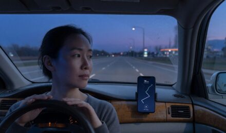 Smartphone displaying car insurance telematics data and driving behavior metrics