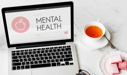 A person reviewing health insurance documents with a focus on mental health denial issues