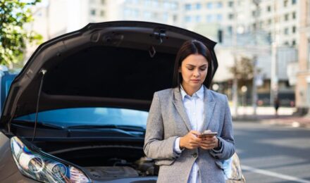 Person reviewing car insurance documents after bankruptcy filing