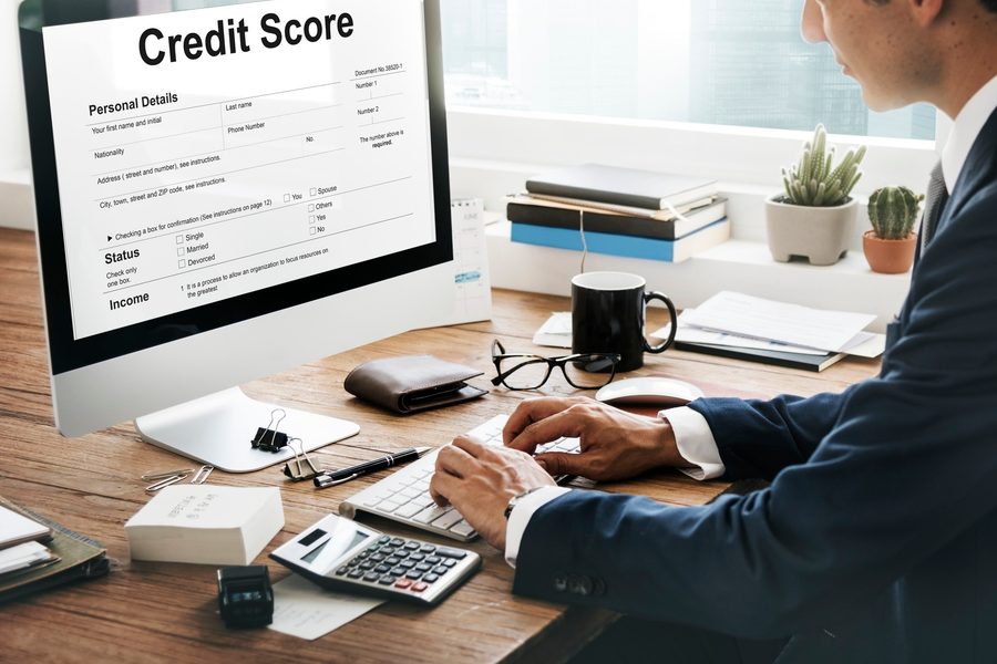 Credit report document next to an insurance policy declaration page