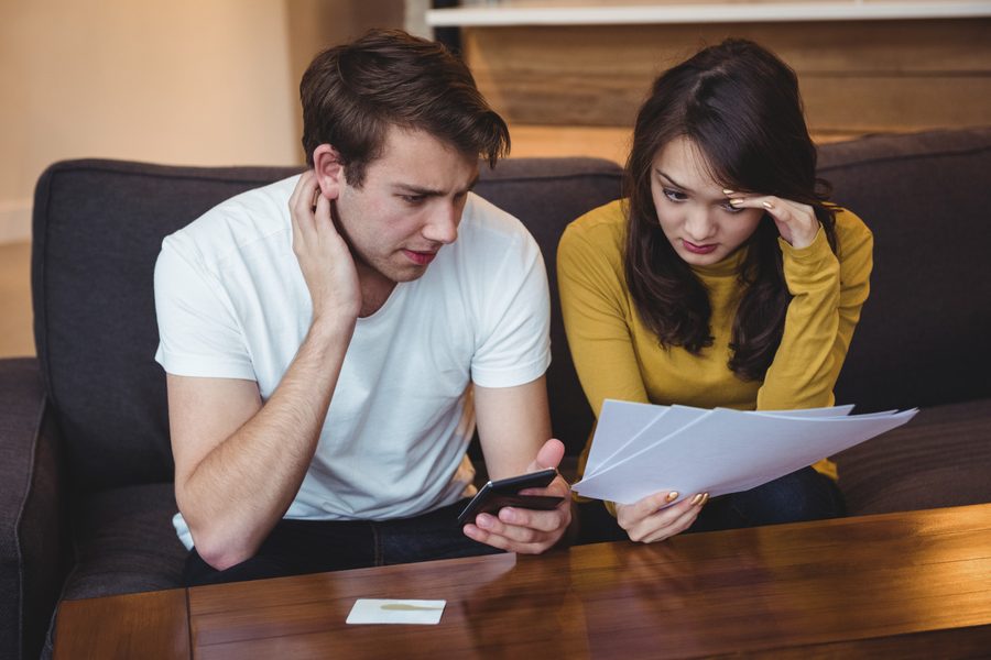 Person on phone with insurance agent while holding a policy document
