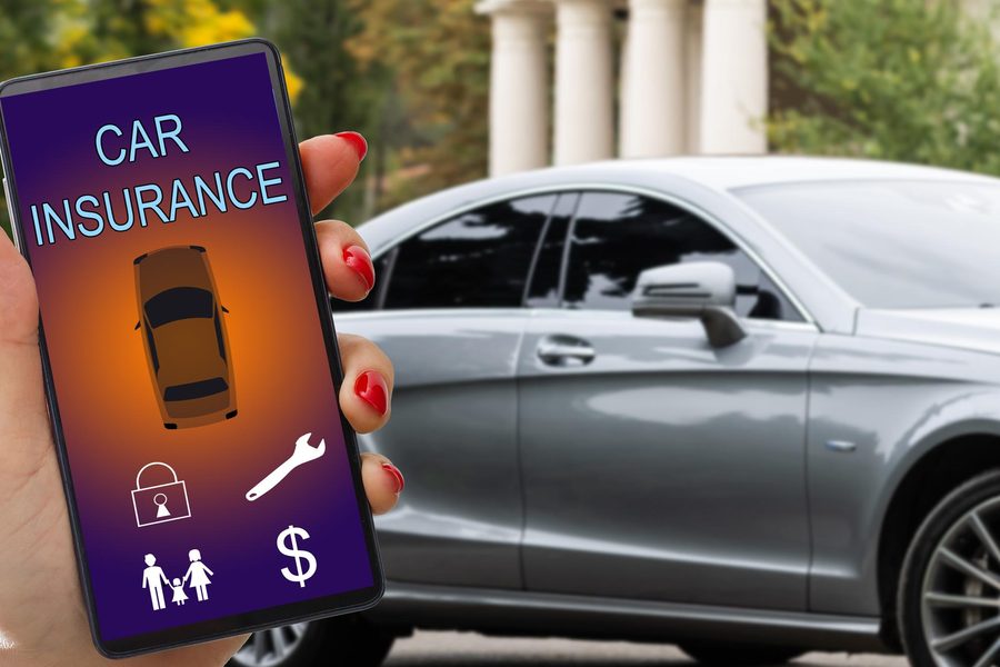 Driver reviewing auto insurance discount options on a laptop