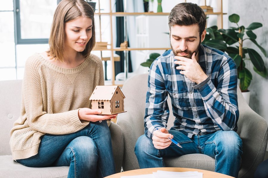 Home interior with no smoking sign and a person working remotely at a desk
