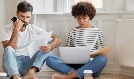 Homeowner reviewing a denied insurance claim letter with documentation and appeal notes on desk