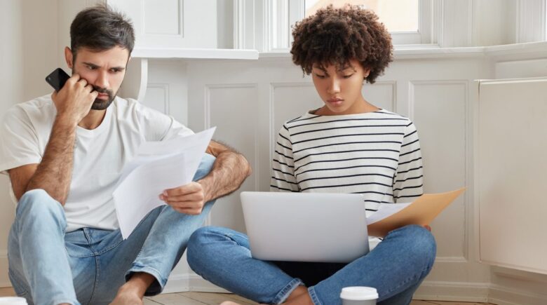 Homeowner reviewing a denied insurance claim letter with documentation and appeal notes on desk