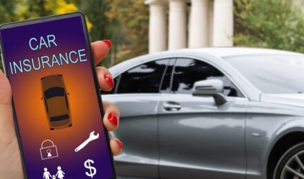Person holding rental car keys after filing an auto insurance claim for vehicle damage
