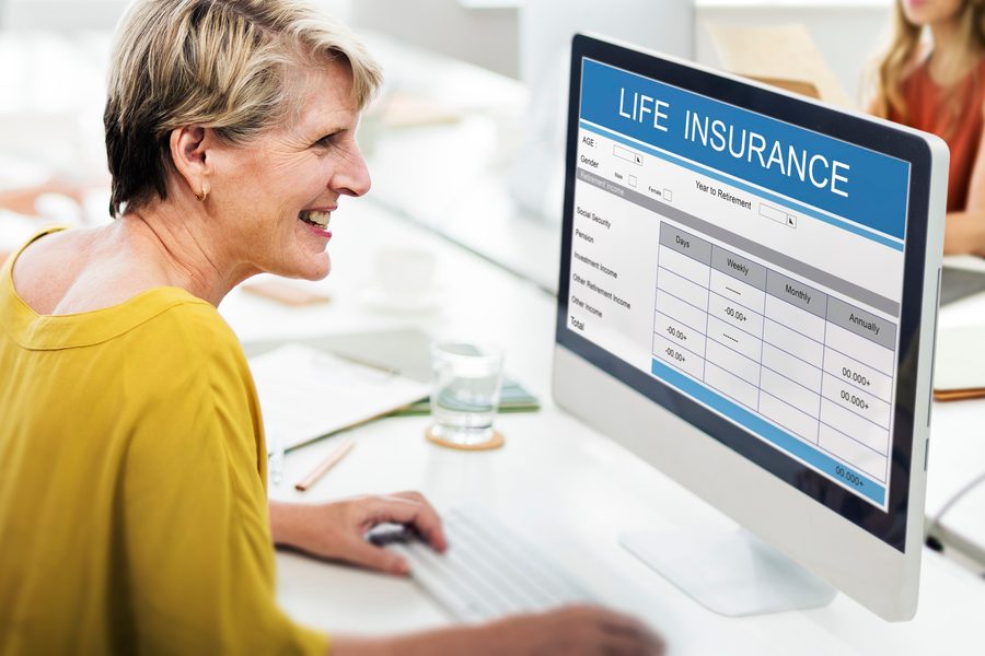 Driver holding an SR-22 certificate form next to a car insurance policy document