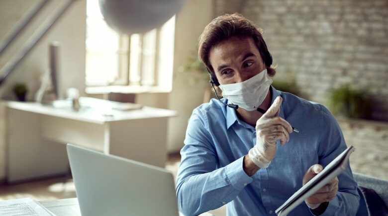 Remote worker with laptop and life insurance policy