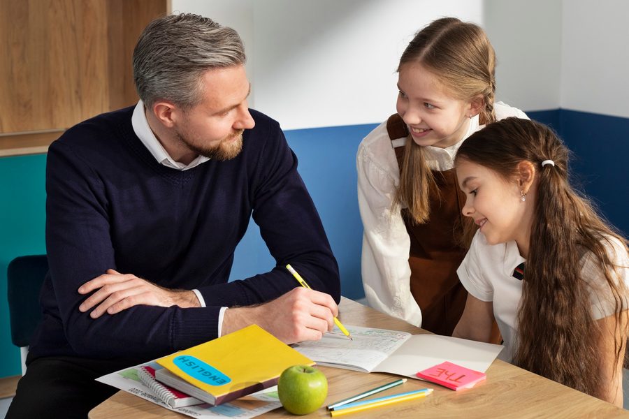 A teacher reviewing a life insurance policy statement at a classroom desk, with the gap between coverage and need highlighted.