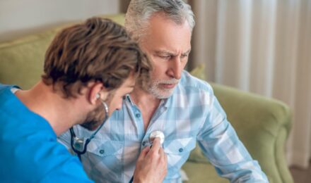 34-year-old man in Arizona reviewing term life insurance policy documents for $800,000 coverage with heart condition