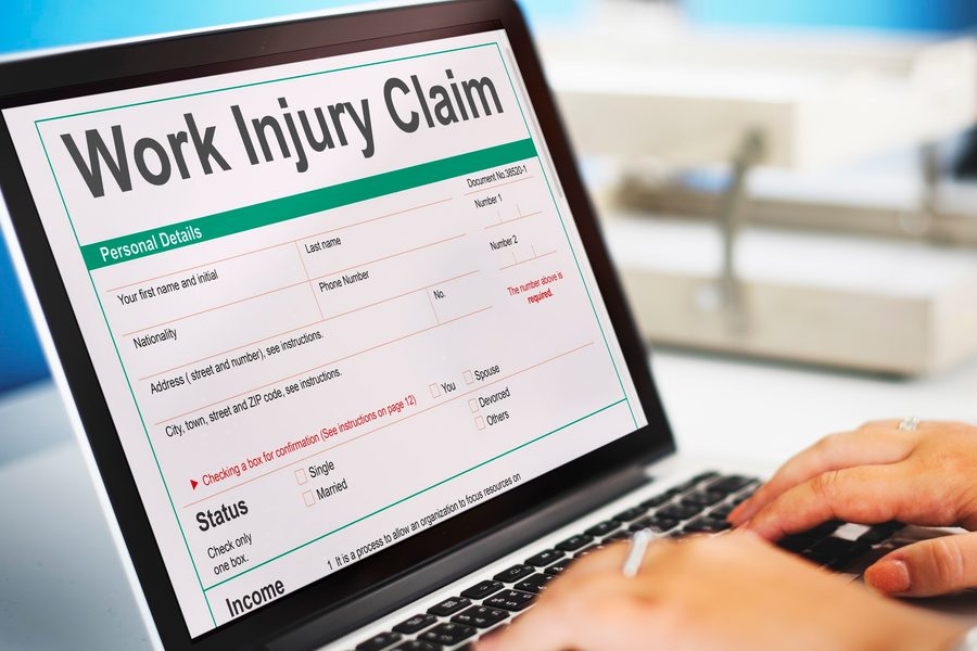 Texas homeowner reviewing claims history documents beside a laptop with insurance quotes